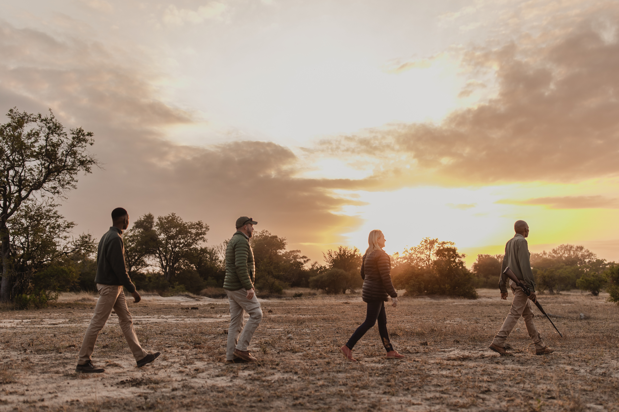 Guests walking through the bush on a guided safari walk with a professional ranger.