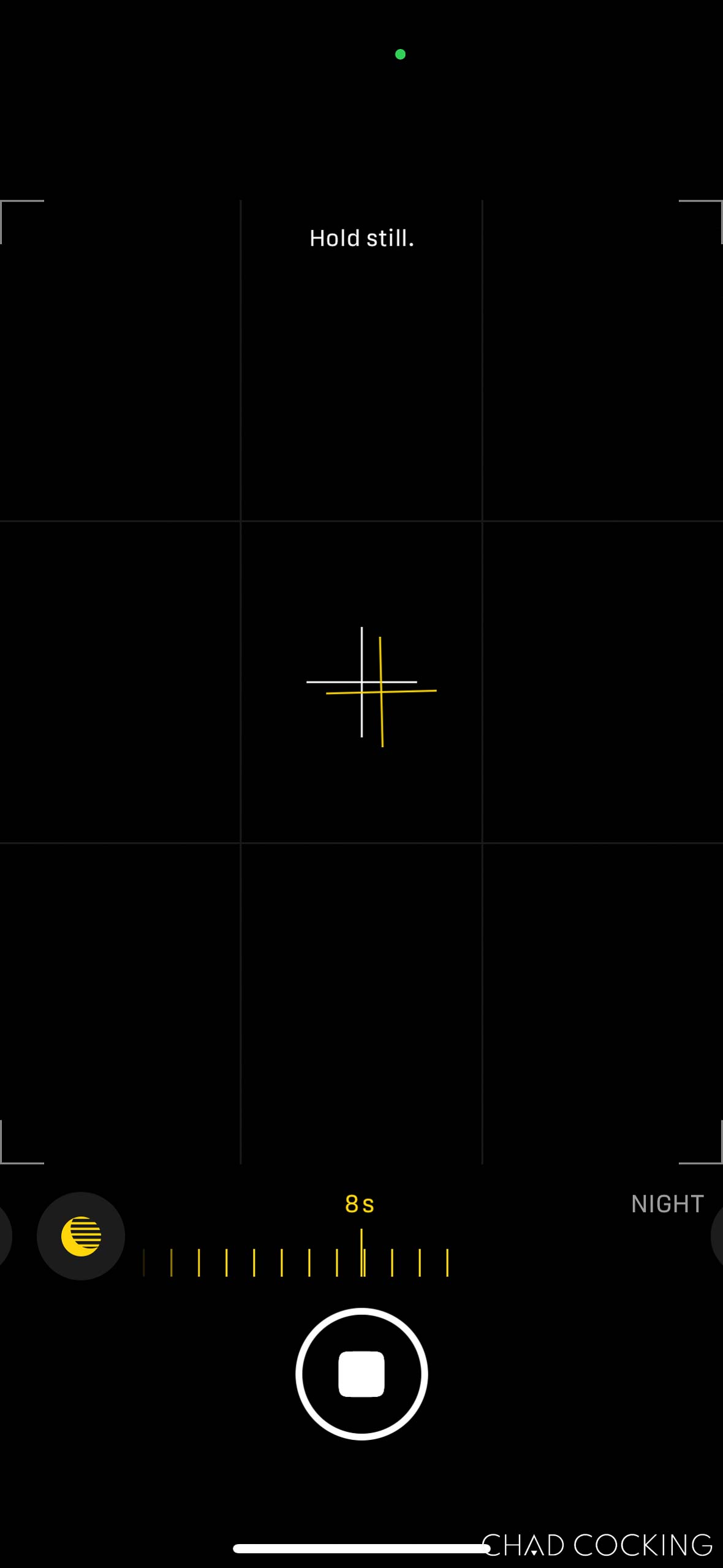 iPhone night mode screen displaying the “Hold still” prompt during long exposure.